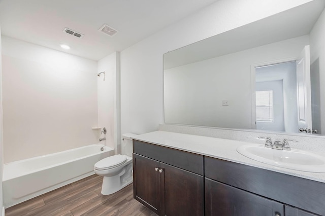 full bathroom featuring hardwood / wood-style floors, vanity, toilet, and shower / bath combination