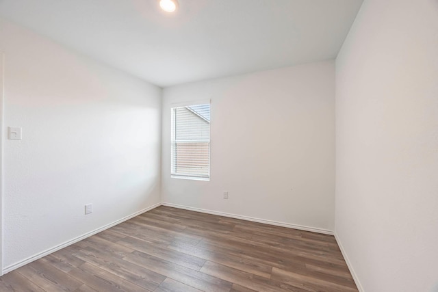 empty room with dark hardwood / wood-style flooring