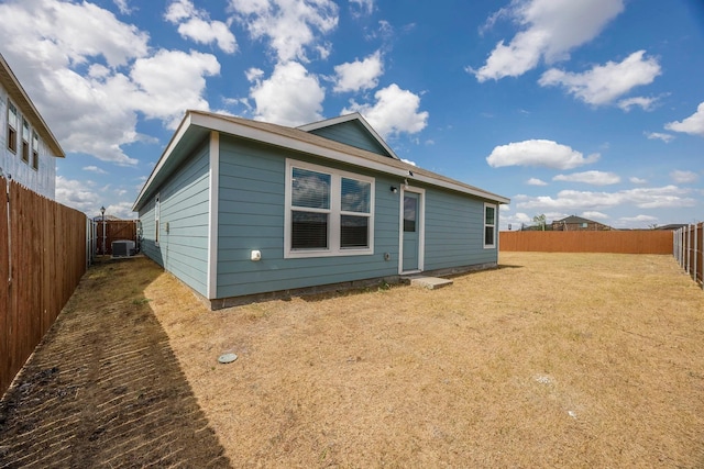 back of house with central AC unit