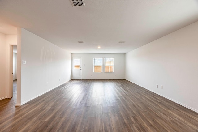 unfurnished room featuring dark wood-type flooring