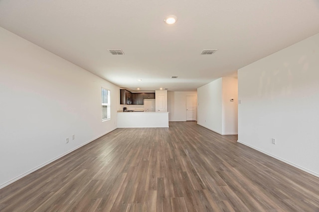 unfurnished living room featuring dark hardwood / wood-style floors