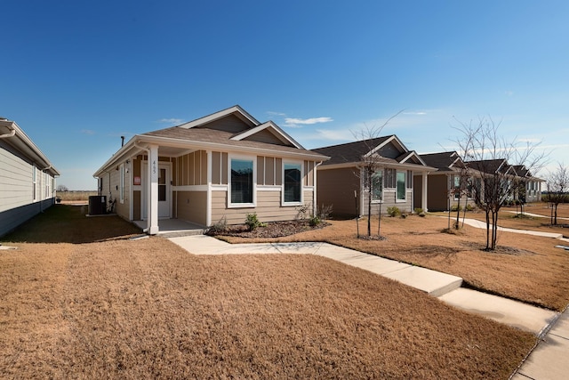 view of front of house featuring a front yard and central AC