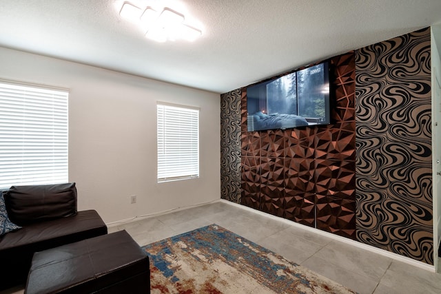 living room featuring a textured ceiling and light tile patterned floors