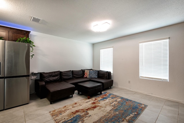 tiled living room with a textured ceiling