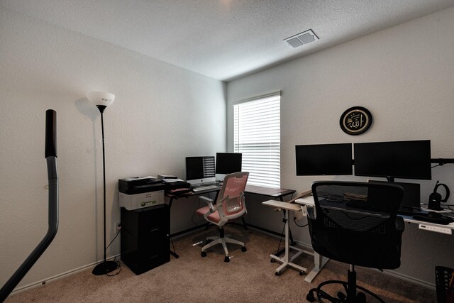 office area featuring light carpet and a textured ceiling