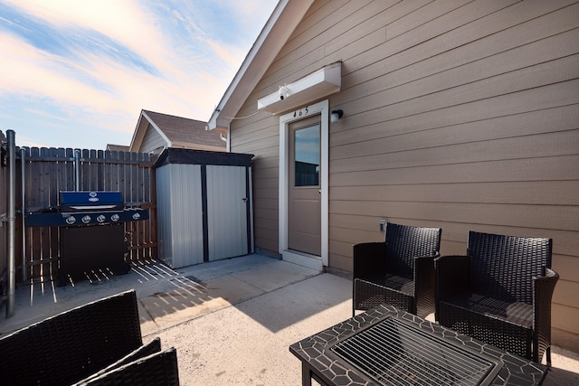 patio terrace at dusk featuring grilling area