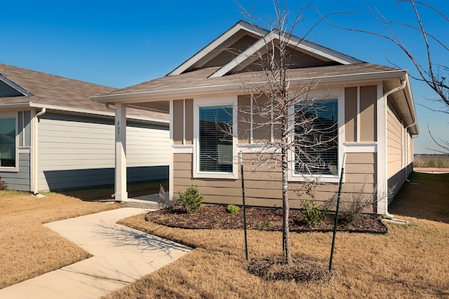 bungalow-style house with a front yard