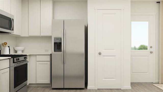 kitchen featuring white cabinetry, light hardwood / wood-style flooring, and stainless steel appliances