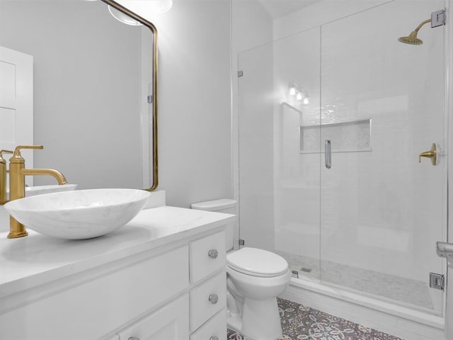 bathroom with tile patterned flooring, vanity, an enclosed shower, and toilet