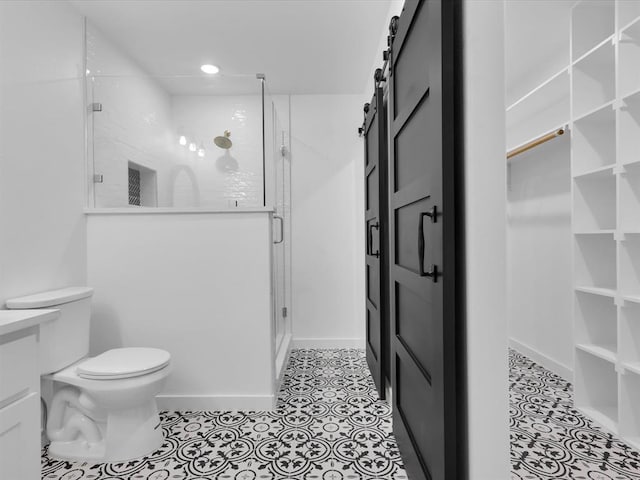 bathroom with tile patterned floors, toilet, and a shower with door