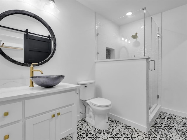 bathroom with tile patterned floors, vanity, toilet, and walk in shower