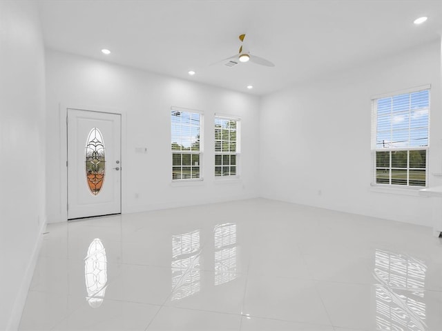 foyer entrance featuring light tile patterned floors and ceiling fan