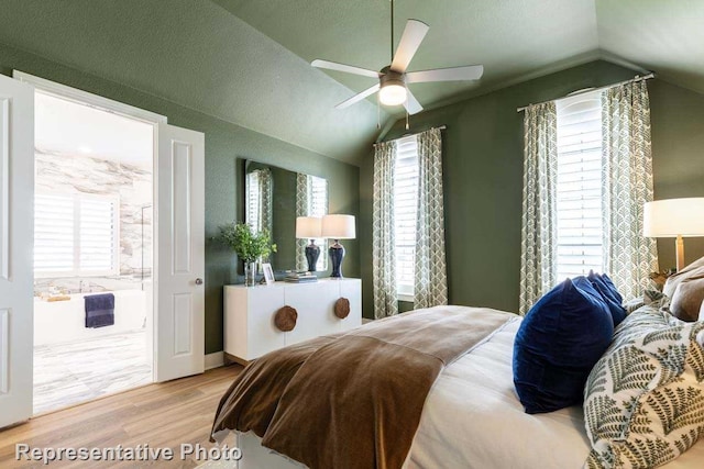 bedroom with ceiling fan, vaulted ceiling, and light wood-type flooring