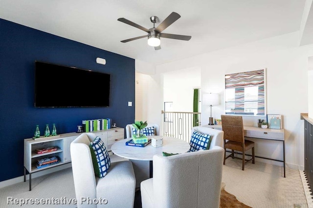 carpeted dining room with ceiling fan