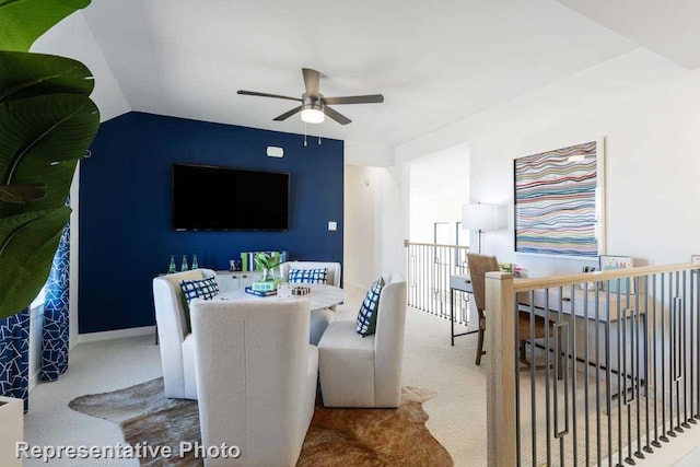 carpeted dining space featuring ceiling fan and lofted ceiling