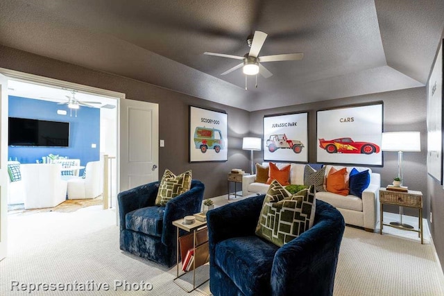 carpeted living room featuring ceiling fan and lofted ceiling