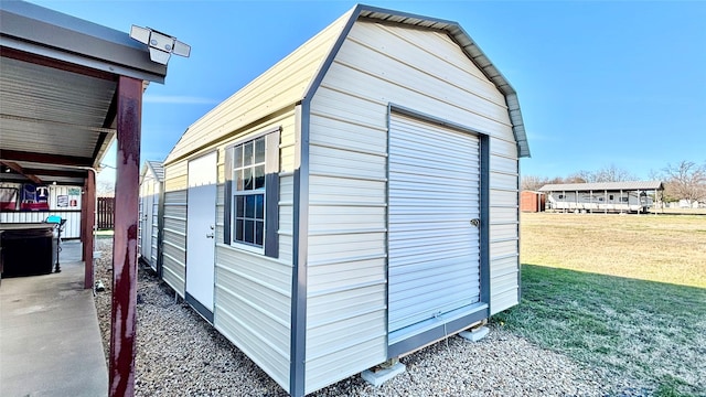 view of outdoor structure featuring a yard and a garage