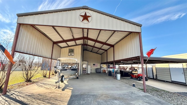 view of parking / parking lot with a carport and a pole building