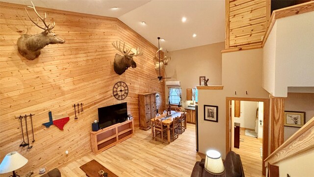 laundry room featuring light hardwood / wood-style floors and stacked washer and dryer