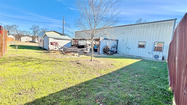 view of yard featuring a storage unit and ac unit