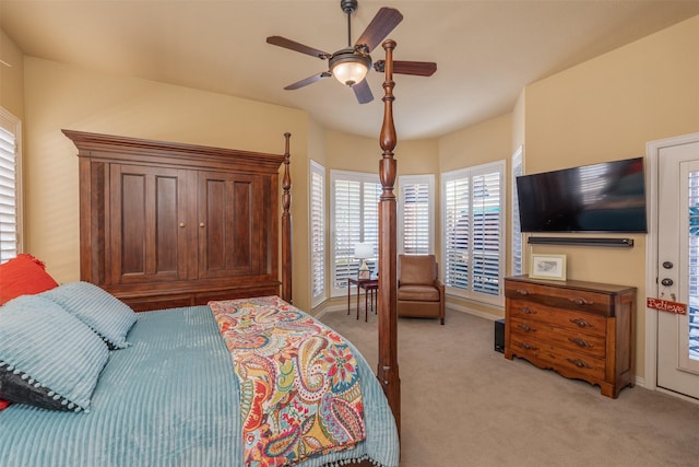 bedroom featuring a ceiling fan, light carpet, and baseboards