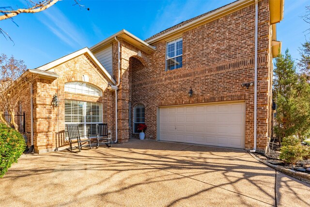 view of front of home with a garage and a front lawn