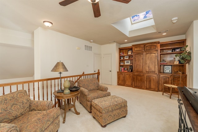 living area with a skylight, light carpet, visible vents, and recessed lighting