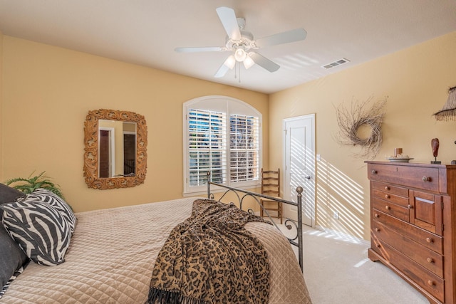 carpeted bedroom with visible vents and a ceiling fan