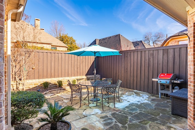 view of patio / terrace featuring outdoor dining area, a fenced backyard, and a grill