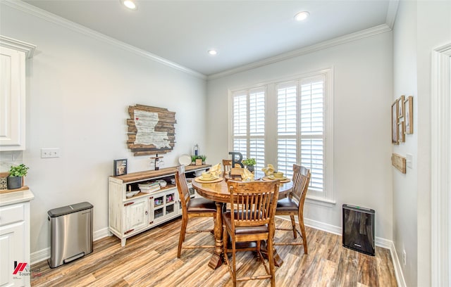 dining room with light hardwood / wood-style floors and ornamental molding