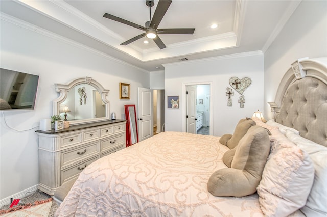 bedroom featuring a tray ceiling, connected bathroom, ceiling fan, and crown molding