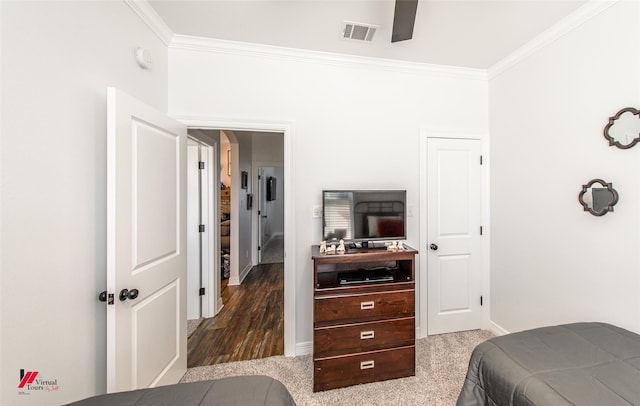 bedroom featuring carpet floors, ceiling fan, and crown molding