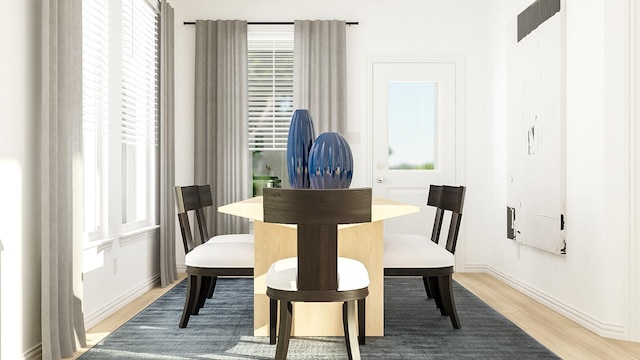 dining room with light wood-type flooring and plenty of natural light