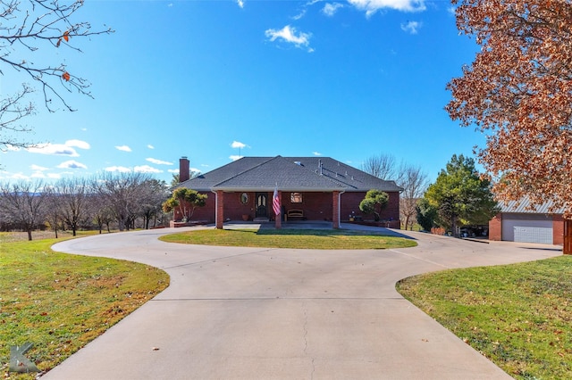 view of front of property featuring a garage and a front lawn