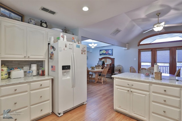 kitchen with white fridge with ice dispenser, light hardwood / wood-style floors, lofted ceiling, decorative backsplash, and ceiling fan with notable chandelier