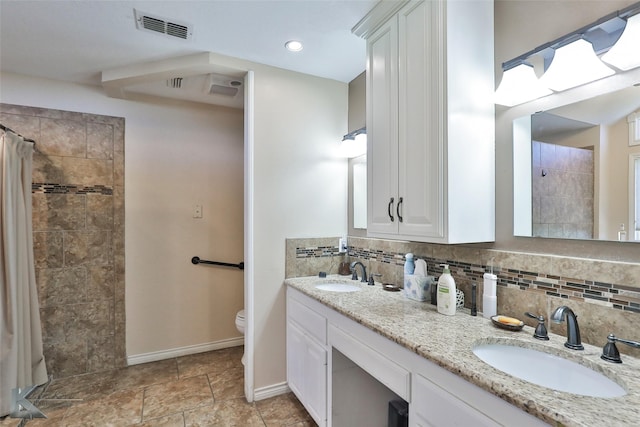 bathroom with tasteful backsplash, curtained shower, vanity, and toilet