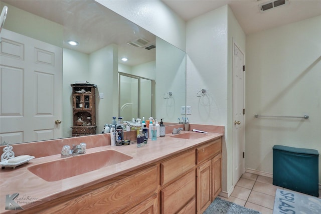 bathroom featuring vanity, tile patterned floors, and walk in shower