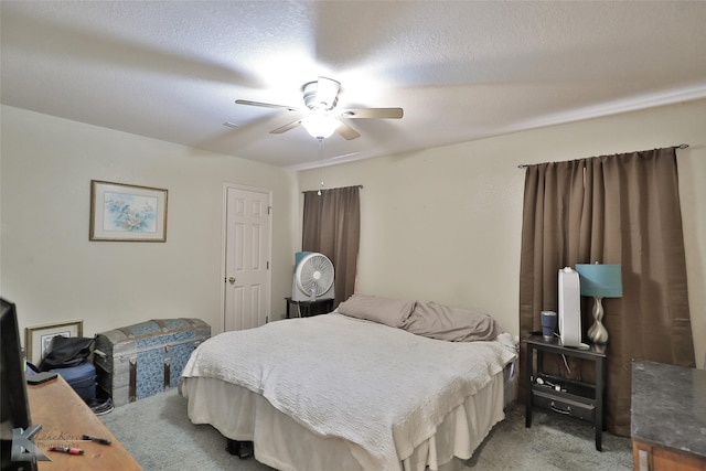 bedroom with carpet flooring, a textured ceiling, and ceiling fan