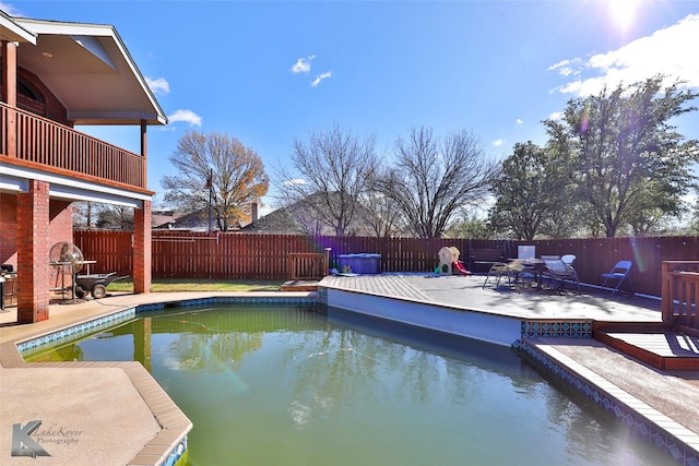 view of swimming pool with a patio