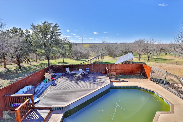 view of swimming pool with a deck