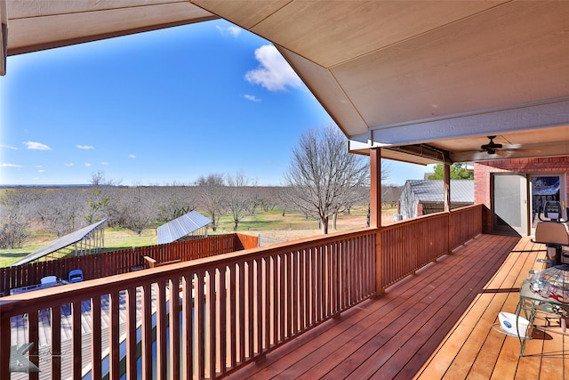 wooden deck featuring ceiling fan