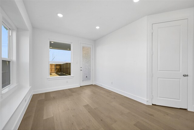 living room with a towering ceiling and hardwood / wood-style floors