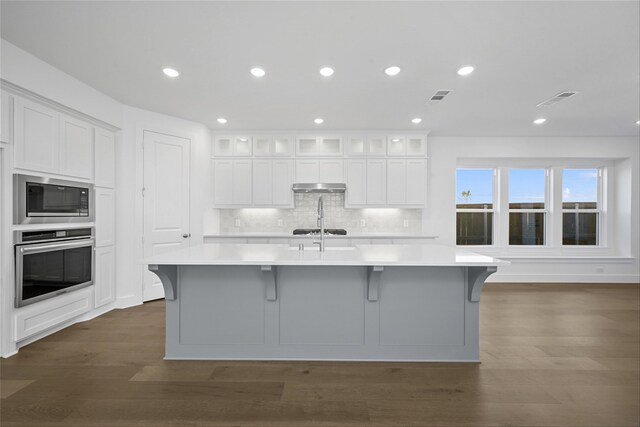 kitchen with white cabinetry, a kitchen island with sink, and appliances with stainless steel finishes