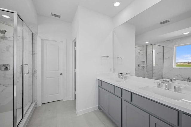 full bathroom with visible vents, a marble finish shower, and a sink