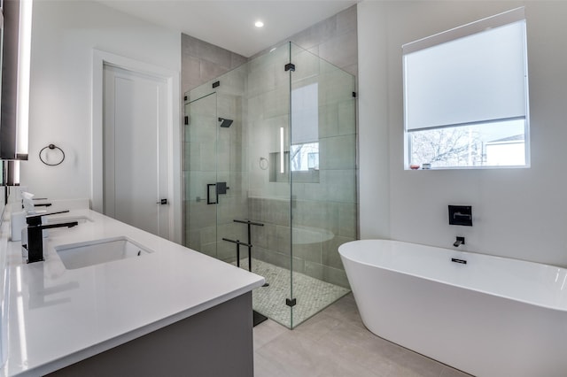 bathroom featuring separate shower and tub, vanity, and tile patterned floors