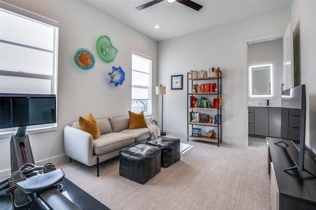 carpeted living room featuring ceiling fan