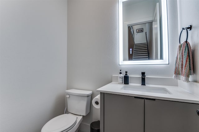 bathroom featuring toilet and vanity