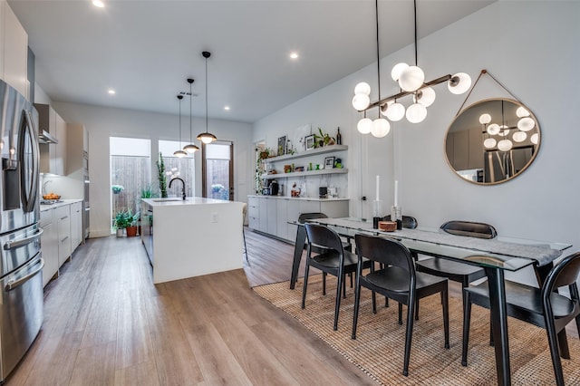 dining area featuring sink and light hardwood / wood-style floors