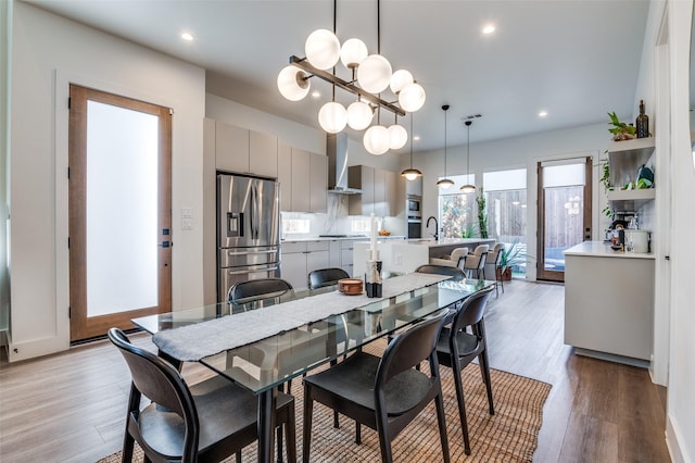 dining room featuring light wood-type flooring and sink