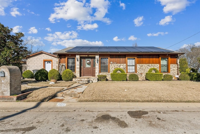 view of front of property with solar panels